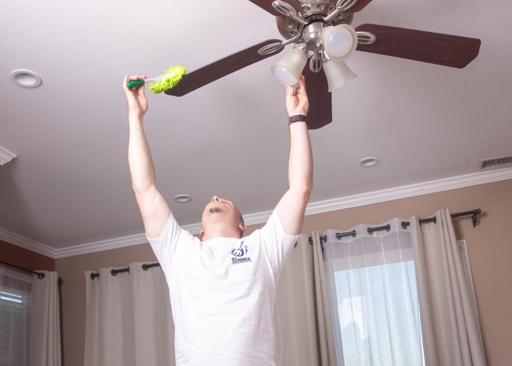 man dusting fan