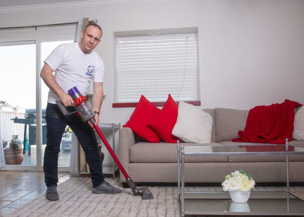 man vacuuming living room